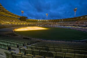 Grand stadium arena field lit up at night, highlighting the ministry compassion sports award dinner at the MCG.