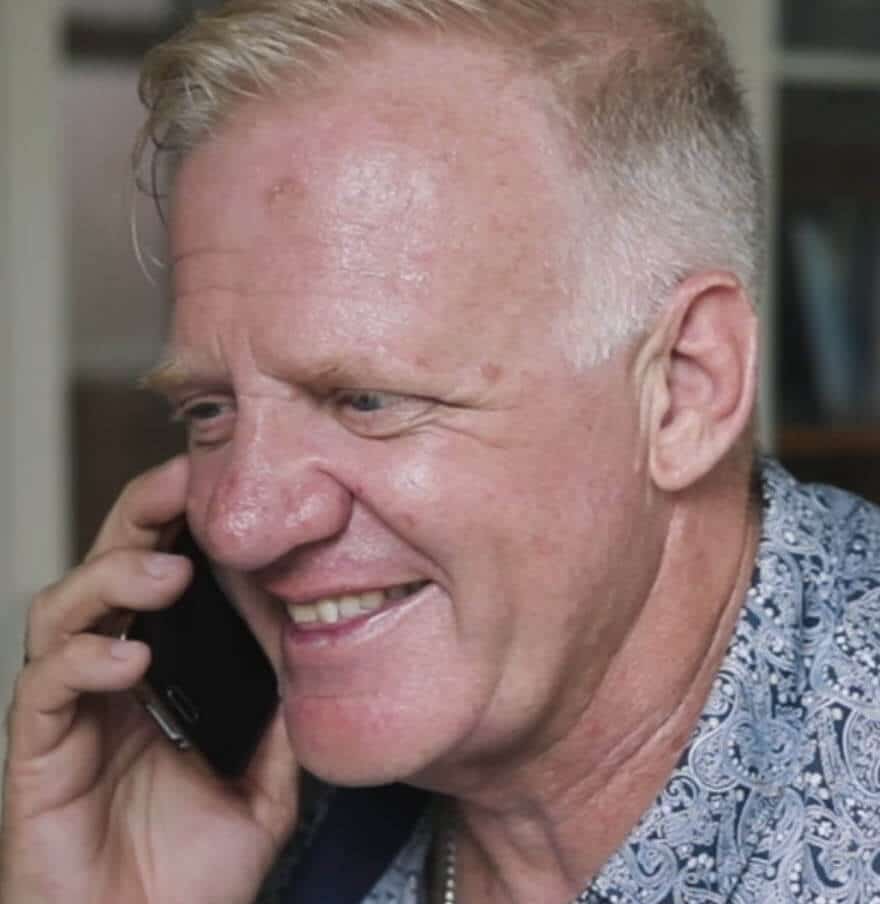 ACS Financial staff member smiling during a phone call, assisting ministry clients with insurance advice.