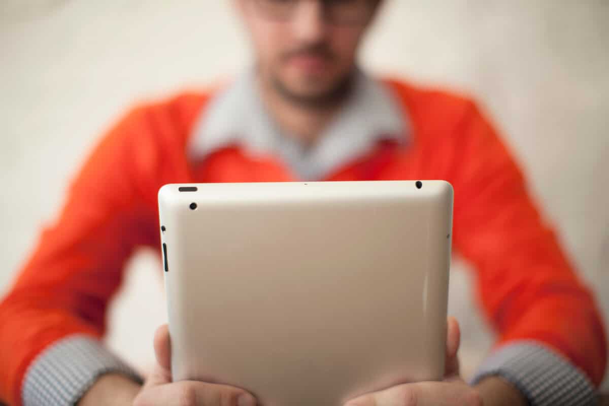 Church administrator review metrics on a tablet, exploring tailored lending options and financial tools.