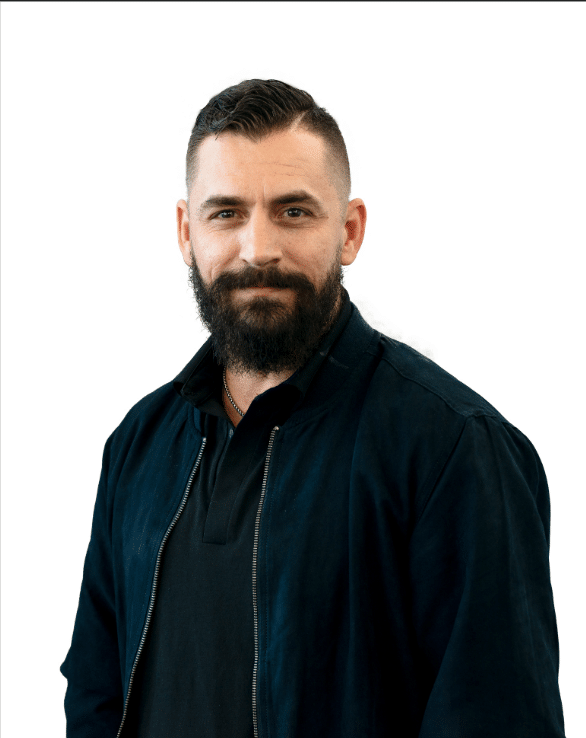 Man with a beard and short hair wearing a black jacket, representing ACS Financial's commitment to tailored travel insurance solutions.
