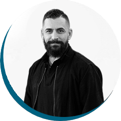 Professional portrait of a man with a beard, wearing a black jacket, representing ACS Financial's commitment to tailored financial services for Christian organisations.