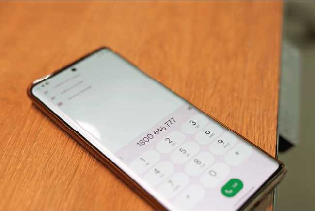 Smartphone showing a phone number dial pad layout, indicating quick access for church insurance inquiries.