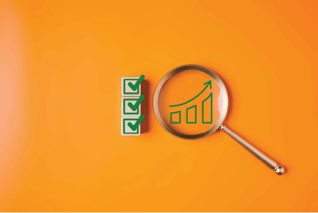 Magnifying glass focusing on a financial growth icon next to green blocks, showcasing ministry investment options.