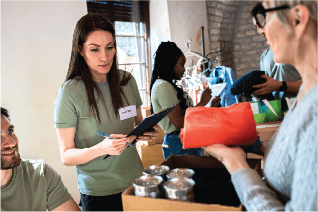 Volunteers organizing donations for a church soup kitchen and food relief initiative, highlighting risk management.