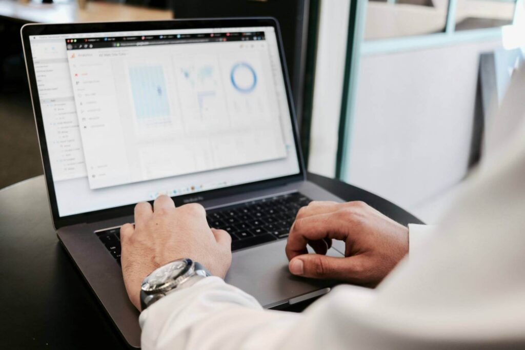 Financial advisor analyzing metrics on a laptop screen to evaluate commercial lending risks for ministries.
