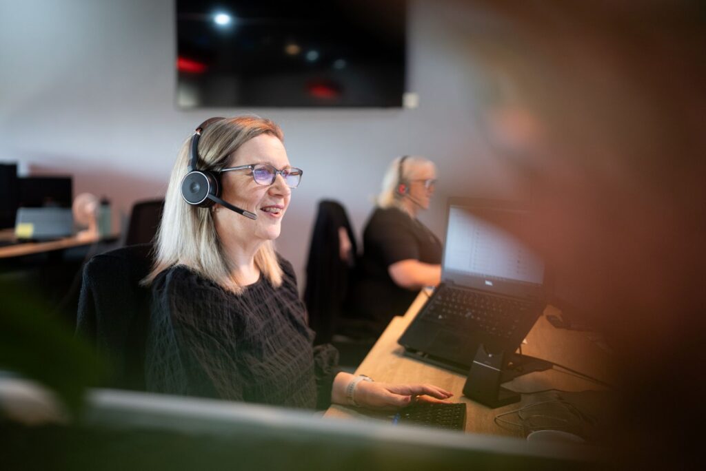 Customer support agents with headsets taking insurance claims and inquiries for church ministry clients.