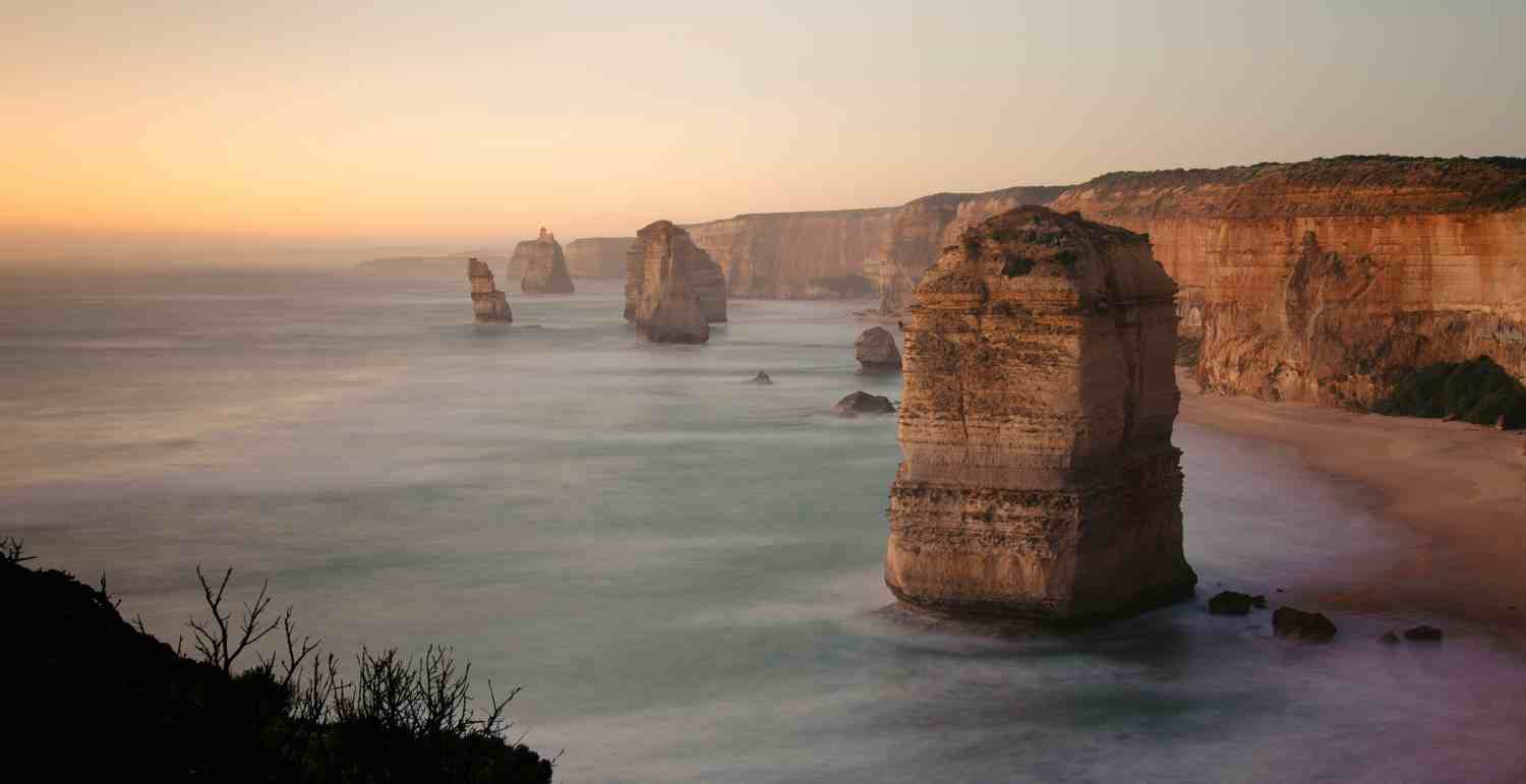 Scenic coastal landscape of the Twelve Apostles at sunset, highlighting Victoria aged care insurance.